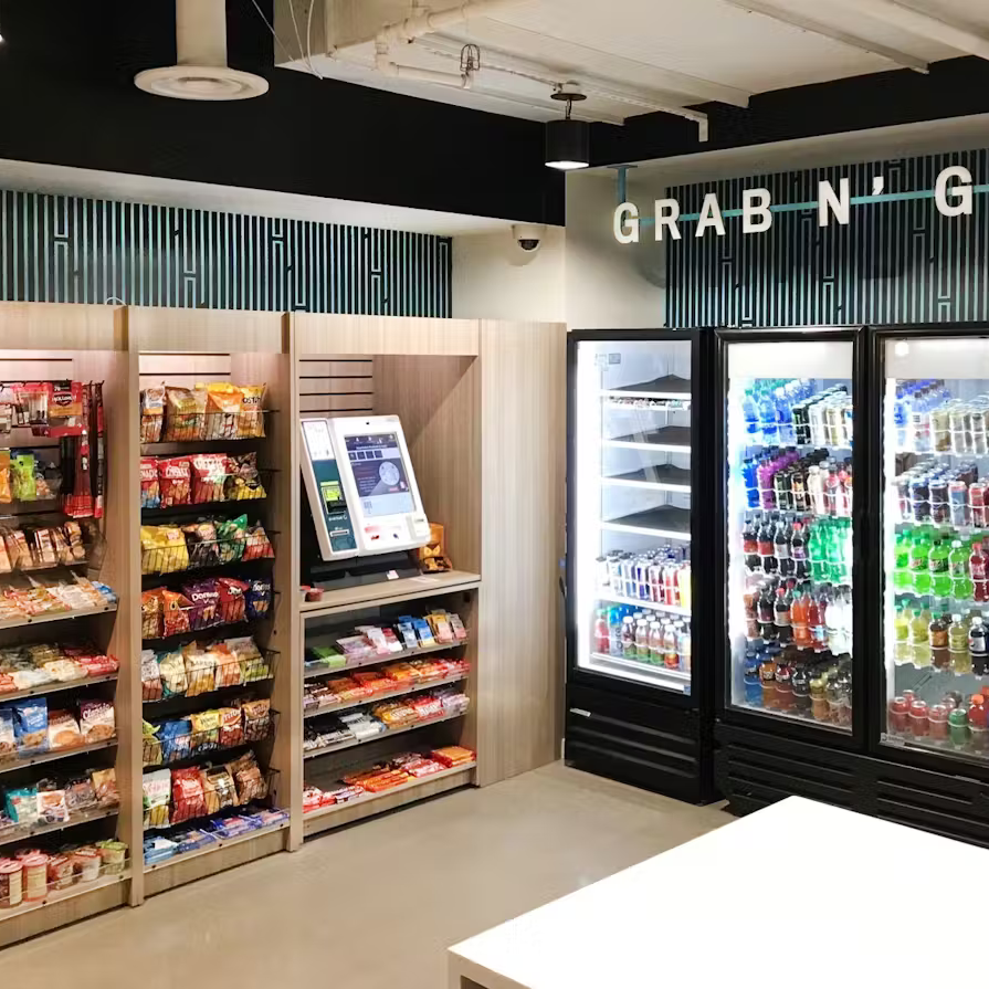 Fully stocked automated checkout market with 3 beverage coolers and 2 snack shelves